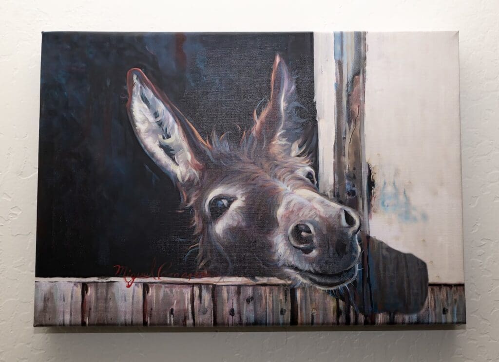 A painting of a donkey looking out the window.