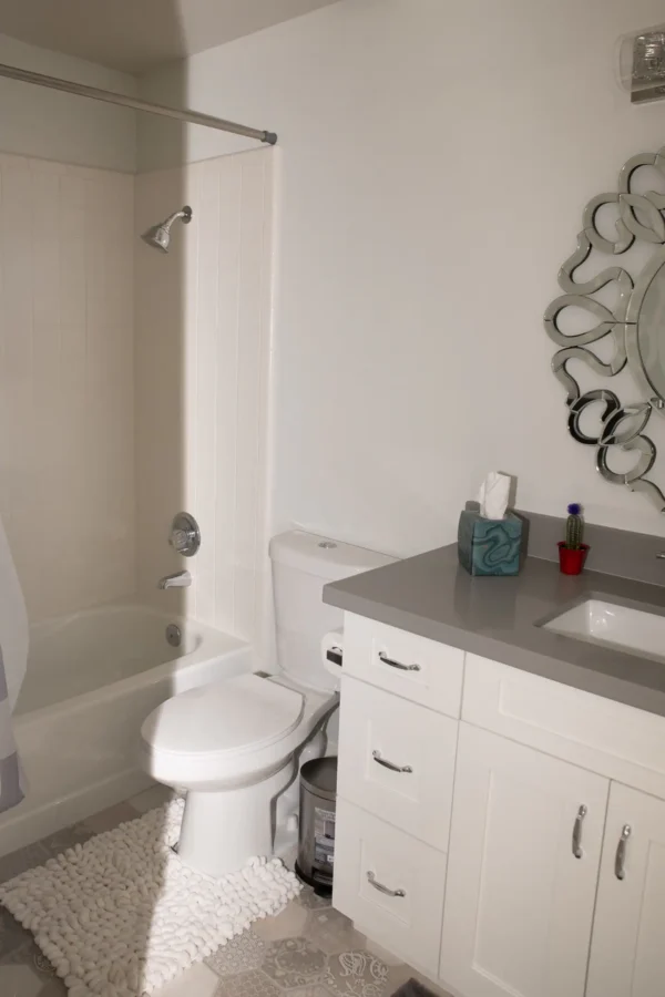 A bathroom with a toilet, sink and bathtub.