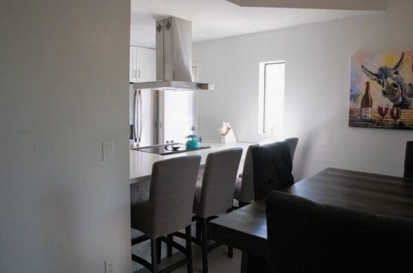 A kitchen with a table and chairs in it