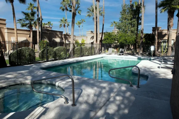 A pool with a few steps down to the water.