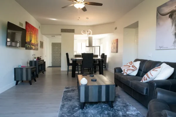 A living room with a couch, table and chairs.