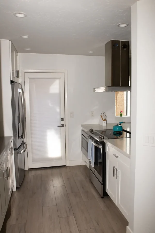 A kitchen with an oven and refrigerator in it