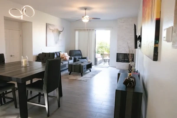 A living room with a fireplace and a table