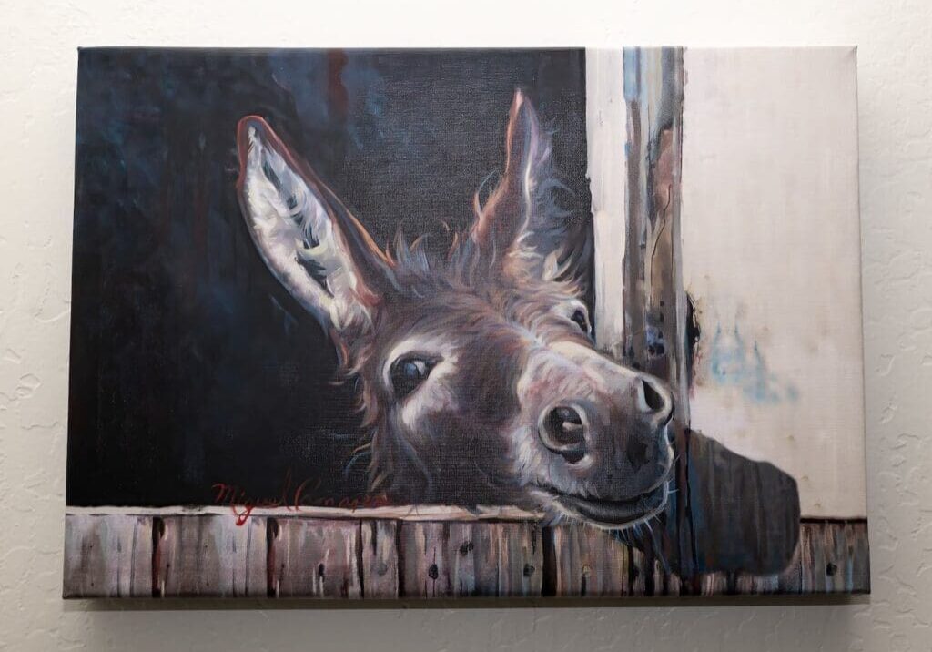 A painting of a donkey looking out the window.